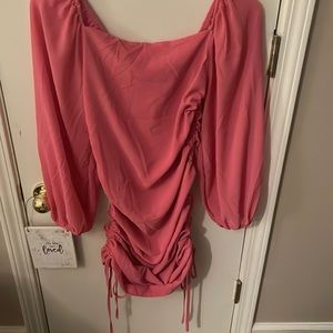 A hot pink mini dress with rushing on the sides!